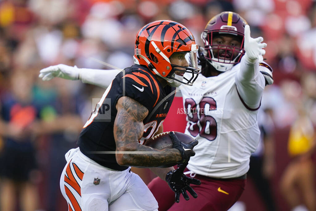 Washington Commanders wide receiver Mitchell Tinsley (86), left,  celebrating his touchdown against the Cincinnati Bengals with teammate  Marcus Kemp (19) and others during the first half of an NFL preseason  football game