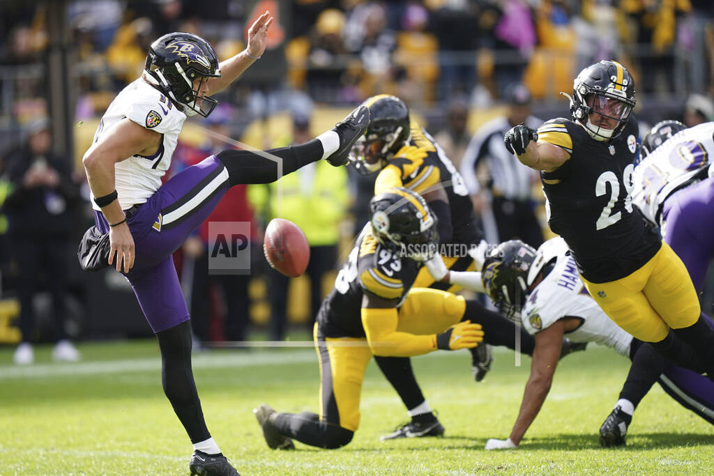 Punter Jordan Stout of the Baltimore Ravens kicks the ball during